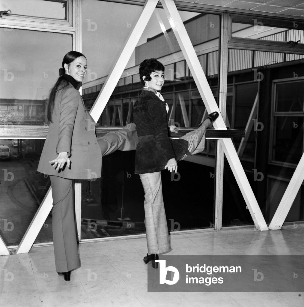 Members of The Royal Ballet left Heathrow Airport for Tokyo today. L-R: Anne Jenner and Anita Young do a ballet exercise before their departure for Tokyo, April 1975 (b/w photo)