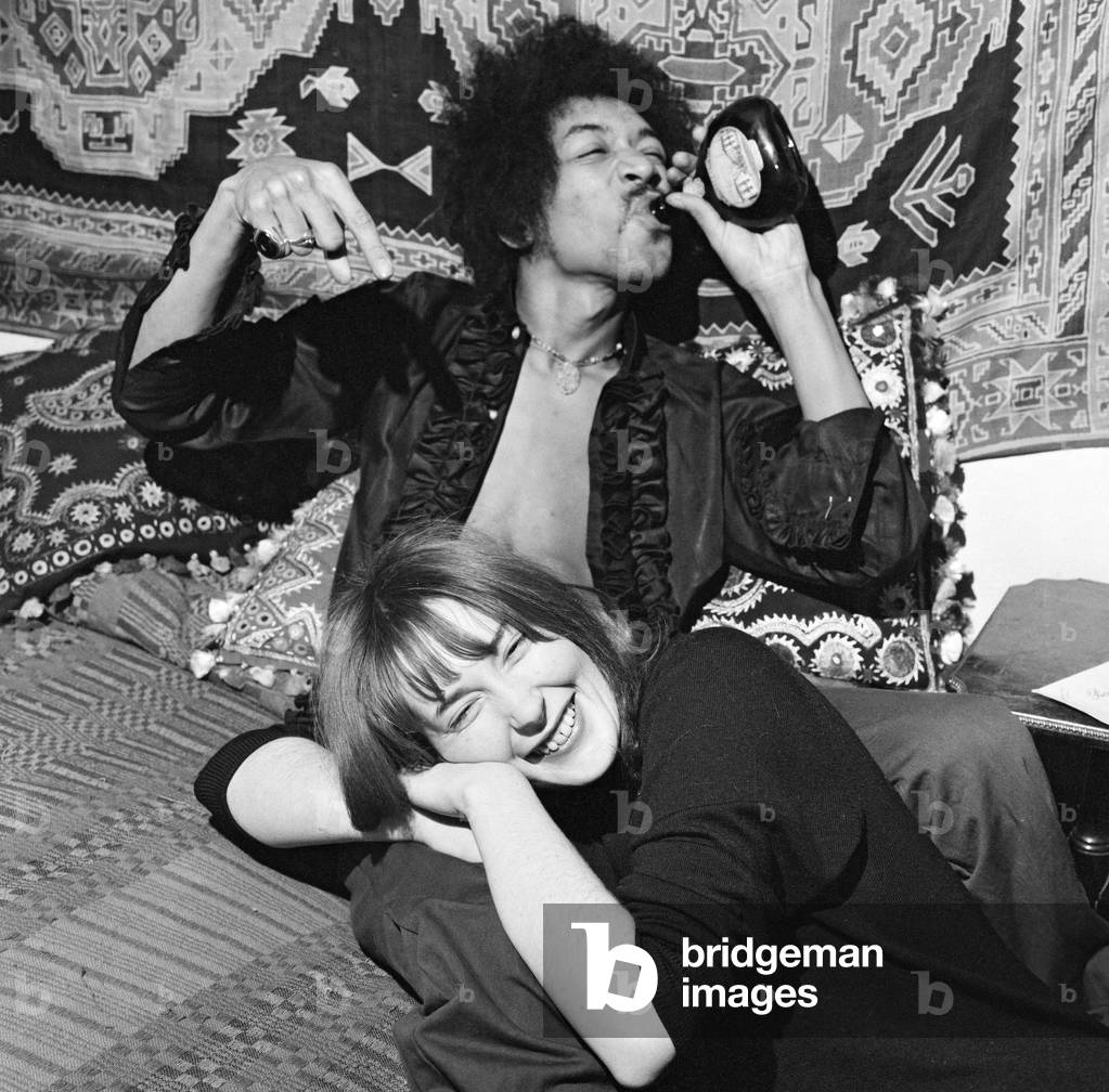 American singer and guitarist Jimi Hendrix (1942-1970) with girlfriend Kathy Etchingham in his Mayfair flat, London. 7th January 1969