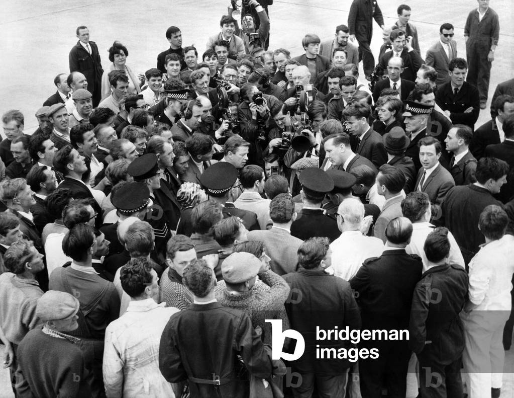 Workers, press men and officials try to get a look at the New Flyweight Champion of the World Walter McGowan, June 1966 (b/w photo)