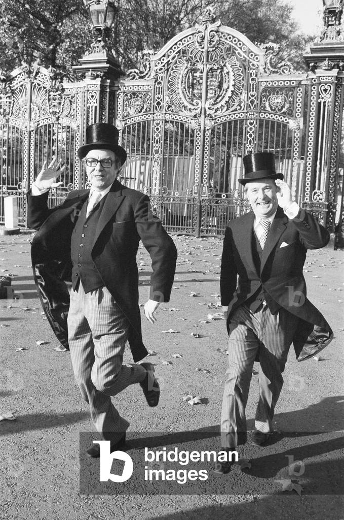 Morecambe and Wise seen here outside the gates of Buckingham Palace doing their Television dance outside Buckingham Palace after they were invested by HM The Queen with the O.B.E. 23rd November 1976
