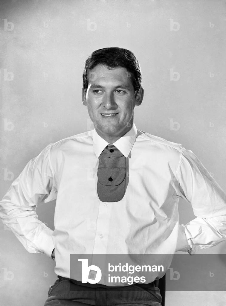 Clothing: Fashion: Menswear: Man wearing shirt and tie. Model: Mike Lester. 1964 (b/w photo)