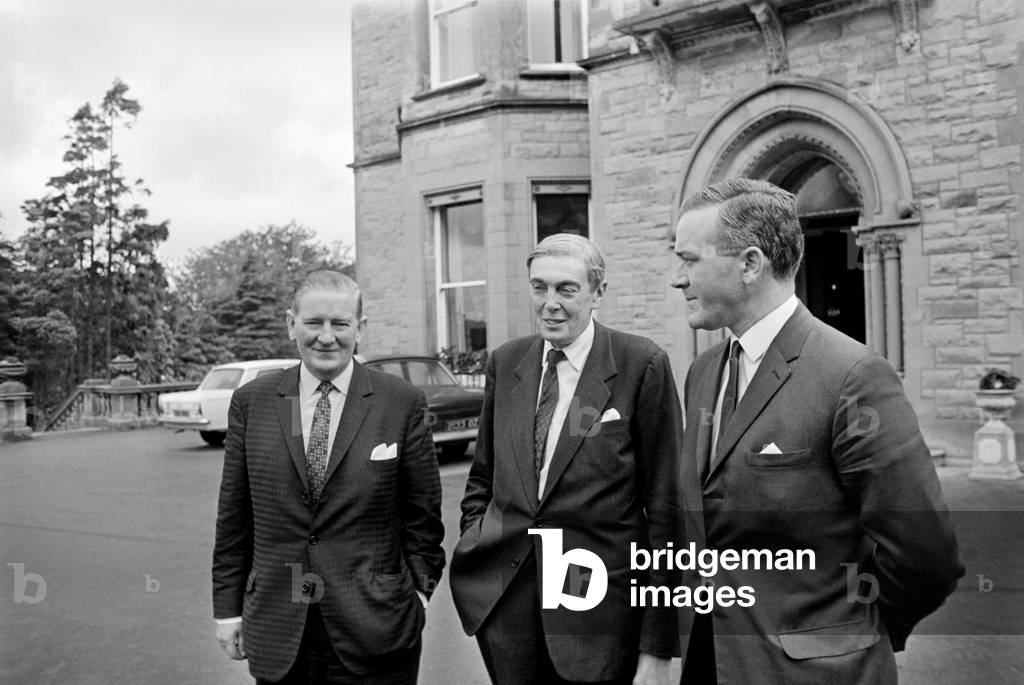 Mr. Justice Scarman (Center), Mr. George Lavery (Left) and Mr. William Marshal walk in the ground of their Belfast Hotel, Northern Ireland.