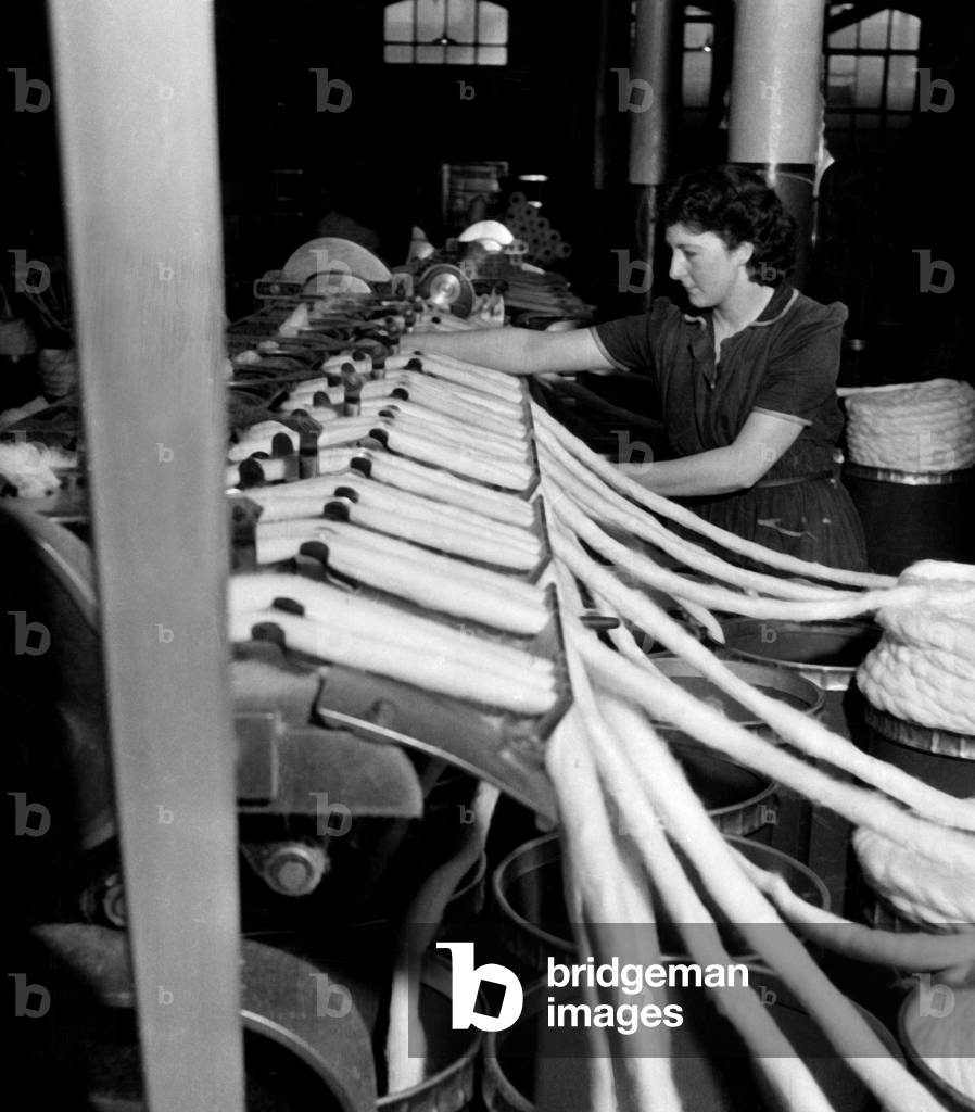 Weaver, Mrs Evelyn Nyland, back at work - after honeymoon - to look after her 25 machines at a Cotton Mill, June 1947 (b/w photo)