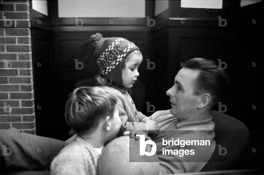 Sport: Football: Derby manager Brian Clough ponders the league cup draw the morning after his team's success at the baseball ground against Crystal Palace. Brian Clough with his two year old daughter Elizabeth watched by his son. October 1969 (photo)
