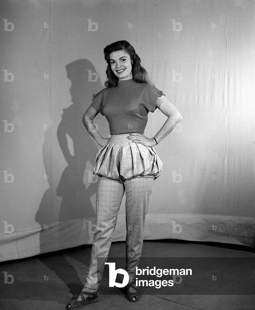 Model wearing bloomer slacks posing with her hands, her hips, 1950 (b/w photo)