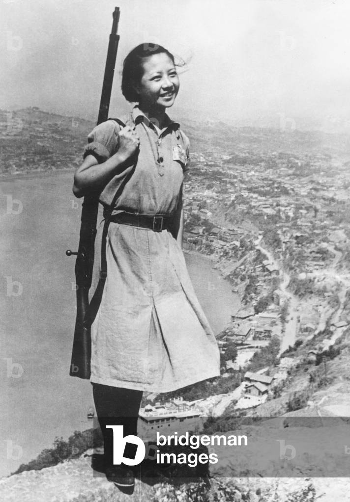 A smiling young girl, who is a soldier in the Chinese army during the Second World War
February 1944