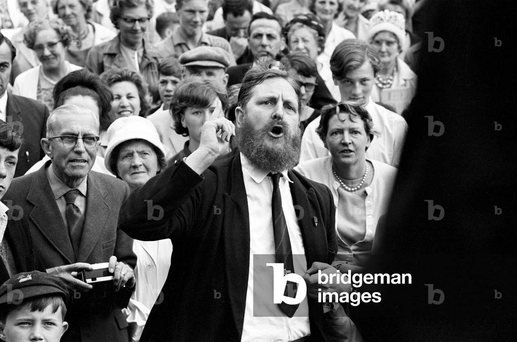Mr Austen Brooks, a member of the League of Empire Loyalists, heckles Conservative Prime Minister Alec Douglas-Home at Ongar. 27th July 1964 (b/w photo)