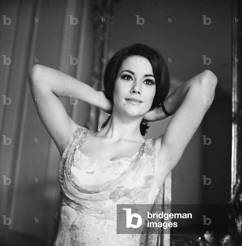 Parisienne actress Claudine Auger who will play Domino in the James Bond film Thunderball, seen here during an interview with the Daily Mirror show business reporter Donald Zec. 17th February 1965 (b/w photo)