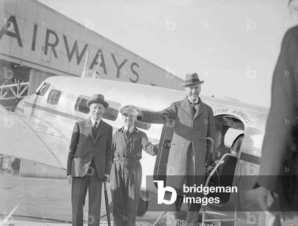 British Prime Minister Neville Chamberlain pictured on his arrival at Heston airport following one of his meetings with German Chancellor Adolf Hitler in his Berchtesgaden mountain retreat, 16th September 1938 (b/w photo)