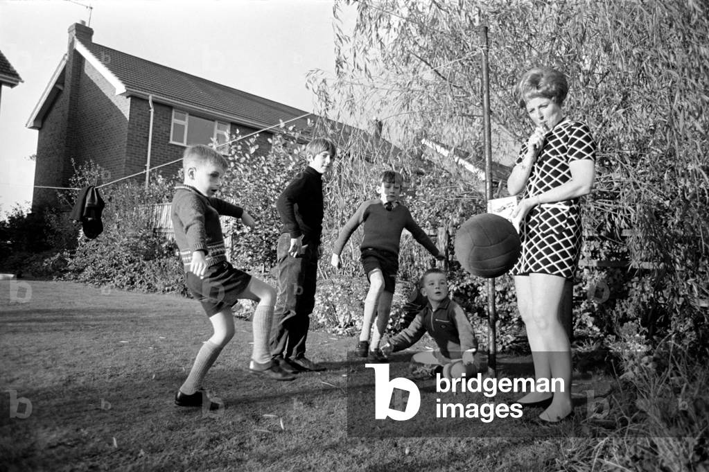 Trainer-coach of the Ashton Junior Football club is ex-model Bobbie Leigh, and during training sessions with the players she carries a rule book, for she is a youth club leader and new to the game of soccer. Bobby Leigh holding a training session with some of the players. November 1969 (photo)