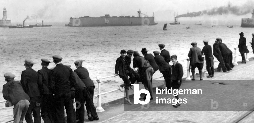 The Wellington Floating Dock seen passing through the Tyne's piers, on its way to New Zealand, a journey that will take seven months in 1931