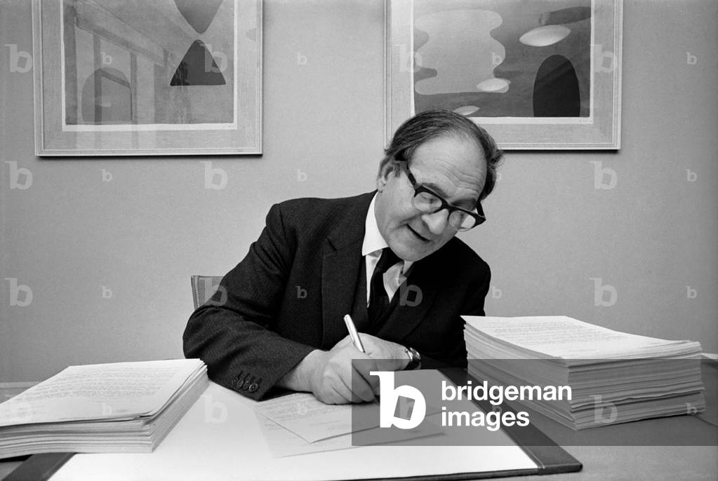 Mr. Fred Mulley, Minister of Transport is sending a personal letter to over 800 newspaper editors throughout the country about road safety at Christmas. Each one is individually signed by Mr. Mulley . The minister at his desk in the Ministry with a pile of letters already signed, and another pile waiting for signature. November 1969