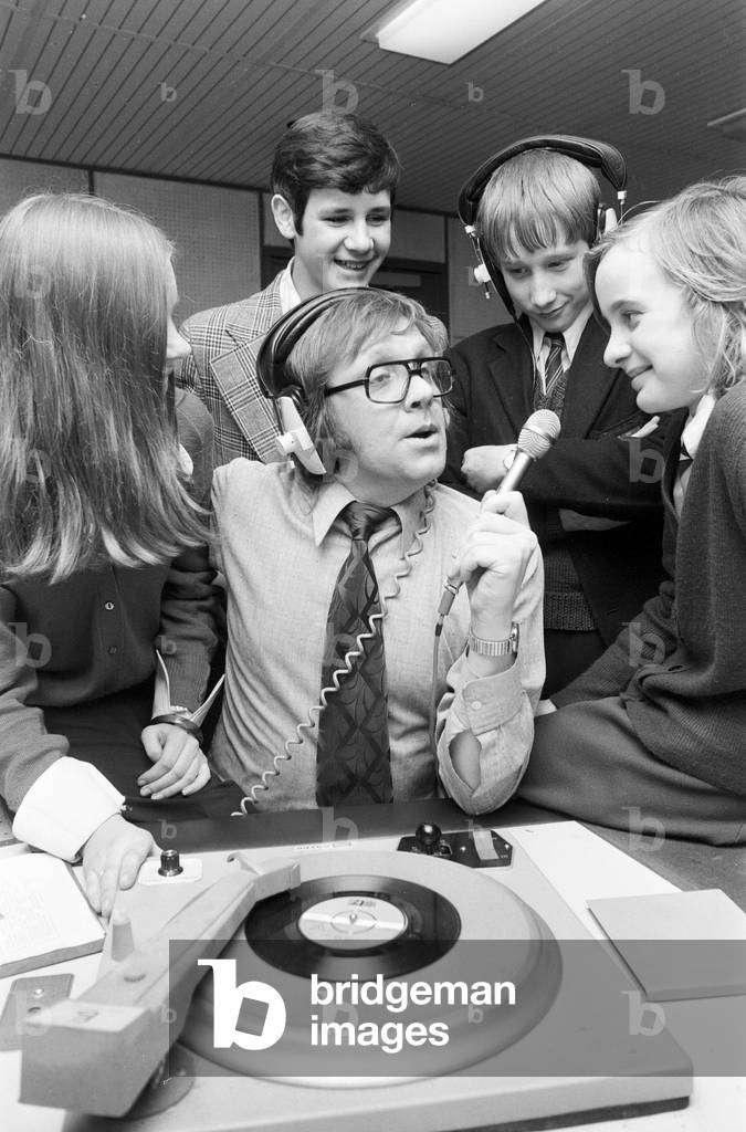 Ed Doolan BRMB Radio Disc Jockey, pictured with news boys and girls, Birmingham, 14th January 1975 (b/w photo)
