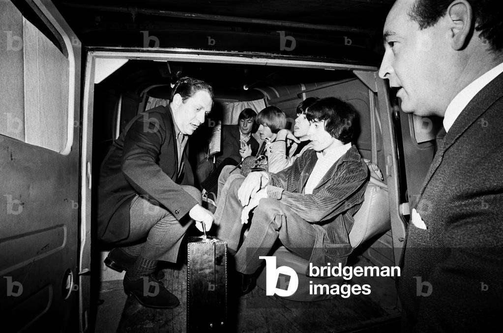 The Rolling Stones bundled in a van outside Manchester's Piccadily Hotel. There was also a decoy van deployed to the gig to try and evade fans.3rd October 1965.