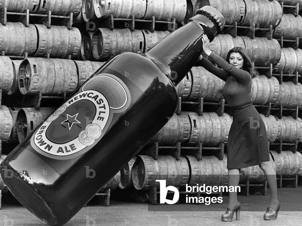 Janette Harper with a Giant Newcastle Brown Ale Bottle 1977 (b/w photo)