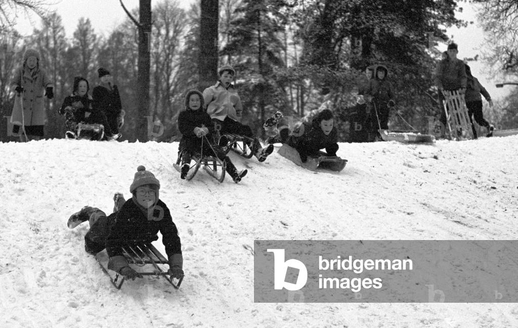 Young children make the most of a cold snap by going sledging at The Grove, Kenilworth Road in Coventry on
3rd January 1963