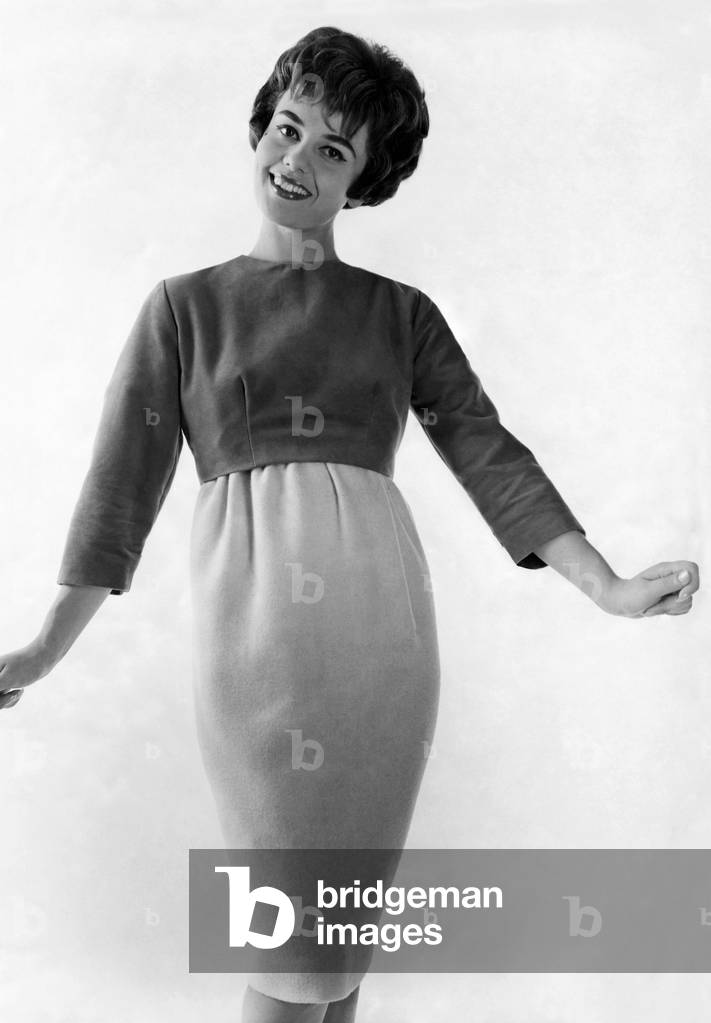 Mannequin wearing a shaped skirt and sweater, April 1959 (b/w photo)