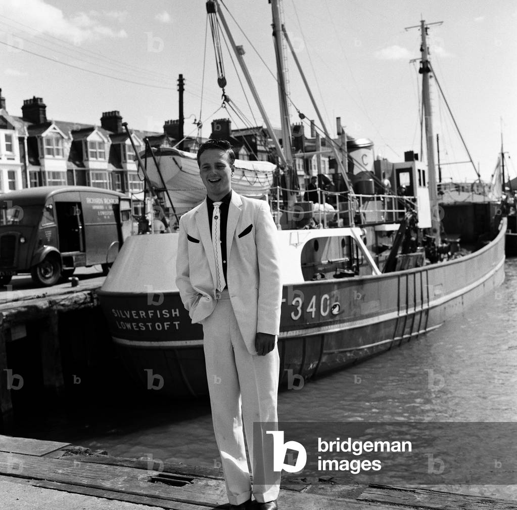 A new craze - Fancy suits worn by trawler fishermen at Lowestoft, Suffolk. Hylton Brighty, aged 16. 19th July 1961 (b/w photo)