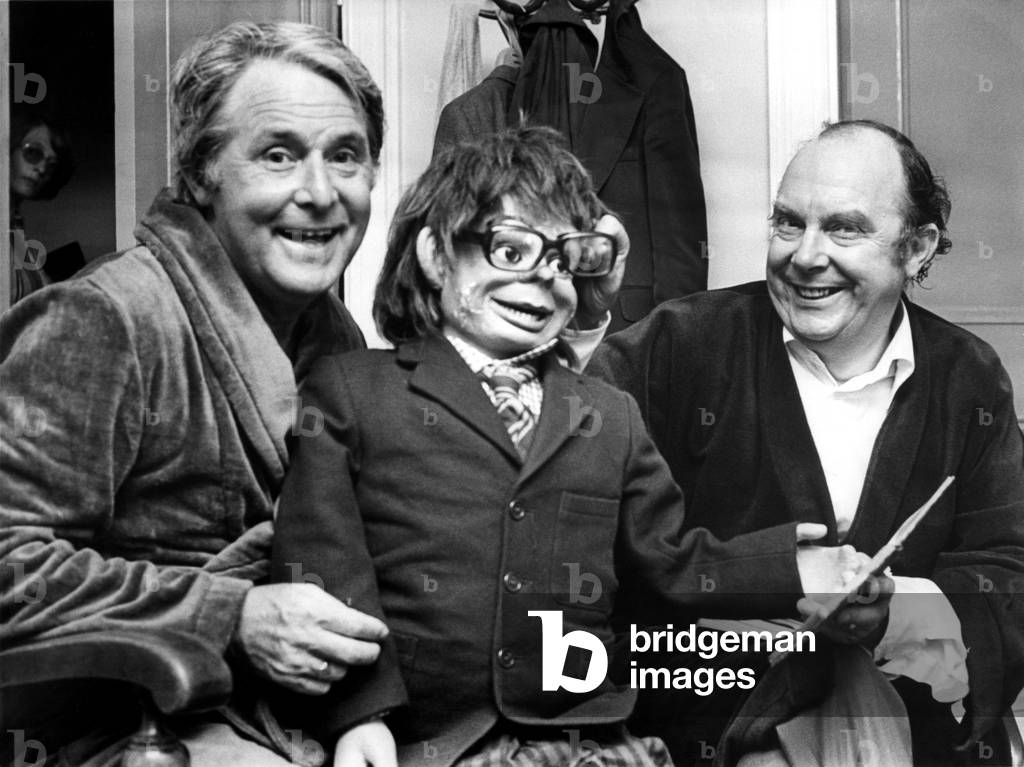 Morecambe & Wise, pictured with a ventriloquist dummy, following a performance at the Newcastle City Hall. ( Eric Morecambe & Ernie Wise.) 25th June, 1977 (b/w photo)