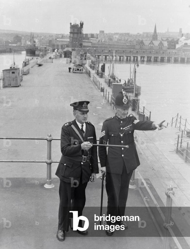 World's smallest police force - The five man Isle of Man harbour Police. Inspector Reginald Wood and Sgt, Benjamin Chapman on Douglas Harbour Control Bridge. 1949 (b/w photo)
