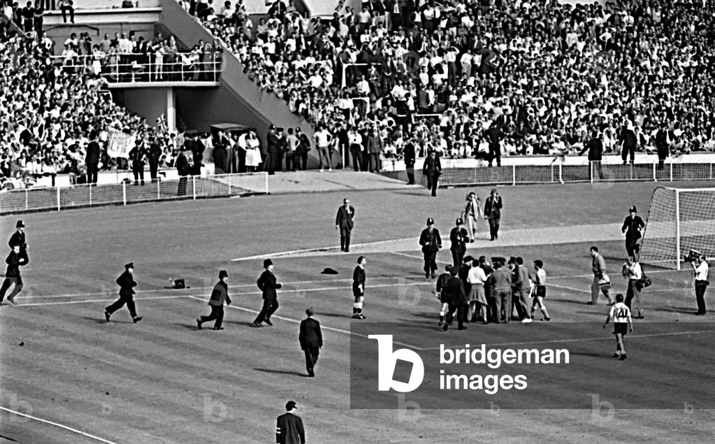 Police on the pitch as England v Argentina World Cup 1966game after final whistle where referee Rudolph Kreitlin was confronted by angry Argentinian players due to Rattinbeing sent off (photo)