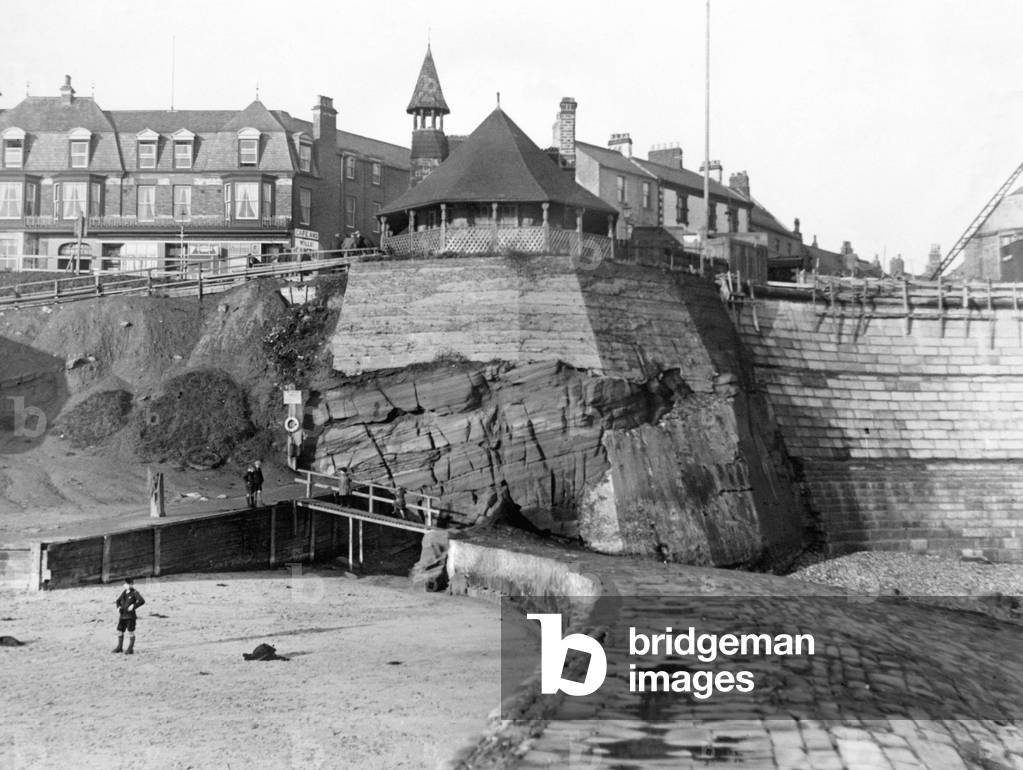 Tynemouth Town Hall Improvement Committee are concerned about the sea erosion at Cullercoats on the North and South ends of the new sea wall. The old watch house on top of the cliff is in danger. 25th January 1932.