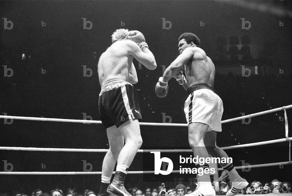 Muhammad Ali lands a punch as Richard Dunn tries to cover up in Munich. 24th May 1976 (b/w photo)