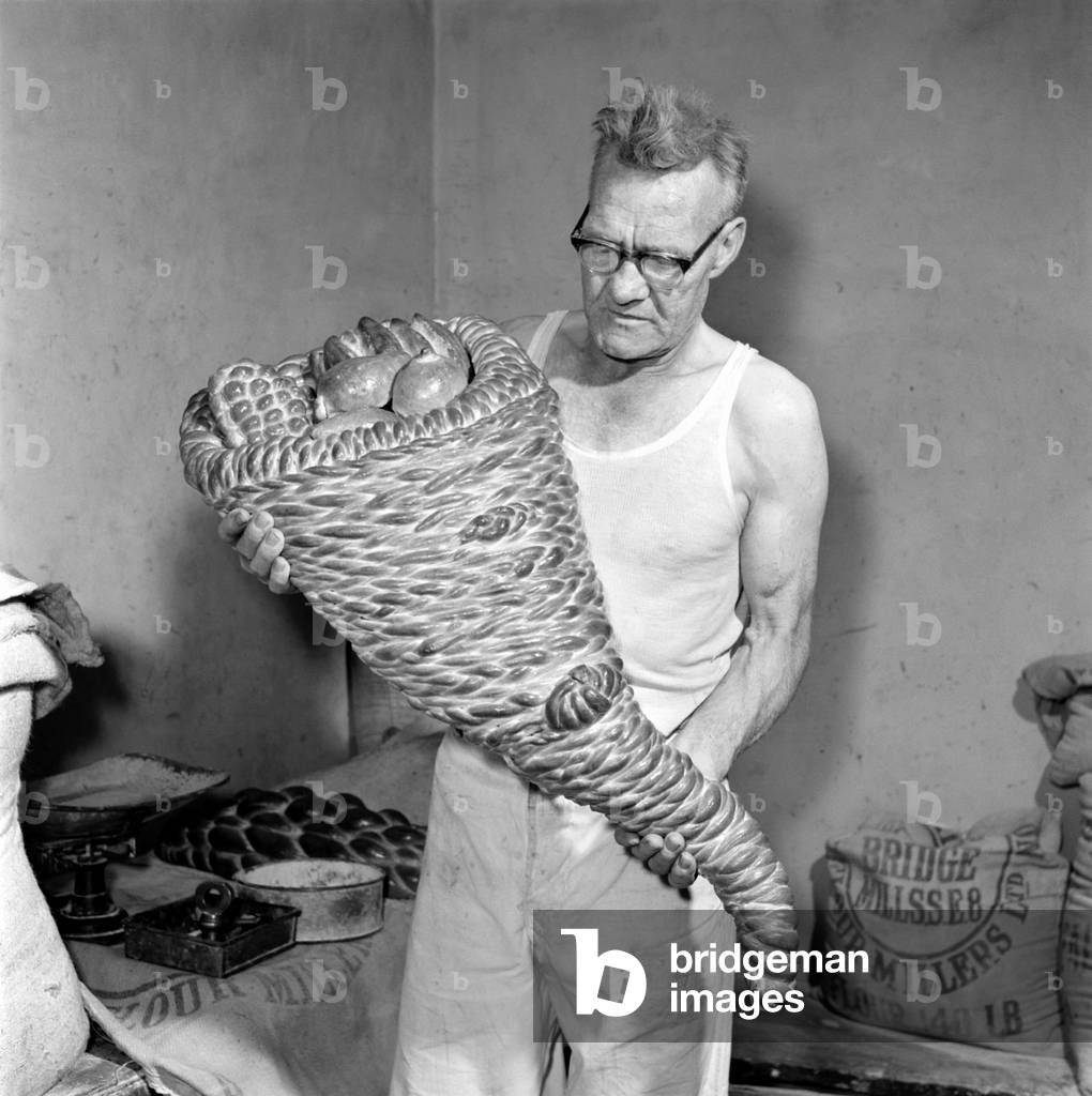 Occupation: Baker: Master baker John Nixey seen here creating sculptures out of bread in his bakery, 1956 (b/w photo)
