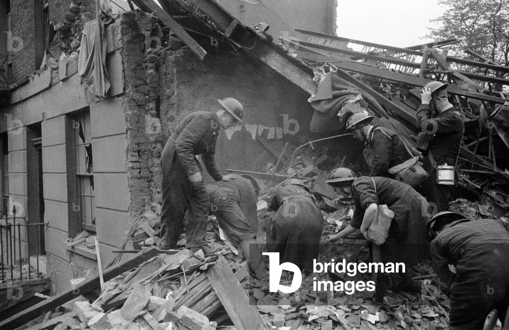 Rescue search in Camden Town after a daylight raid, 1940 (b/w photo)