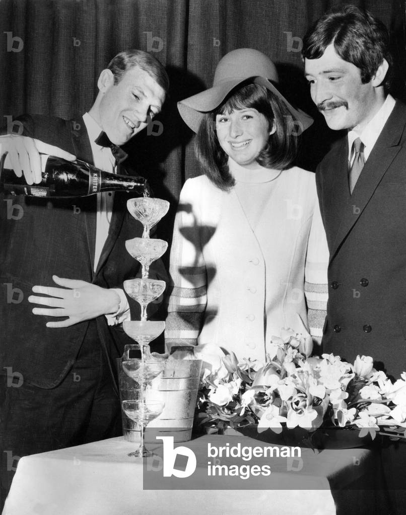 Derek Bower, wine waiter at the Moulin Rouge pours six champagne glasses at once