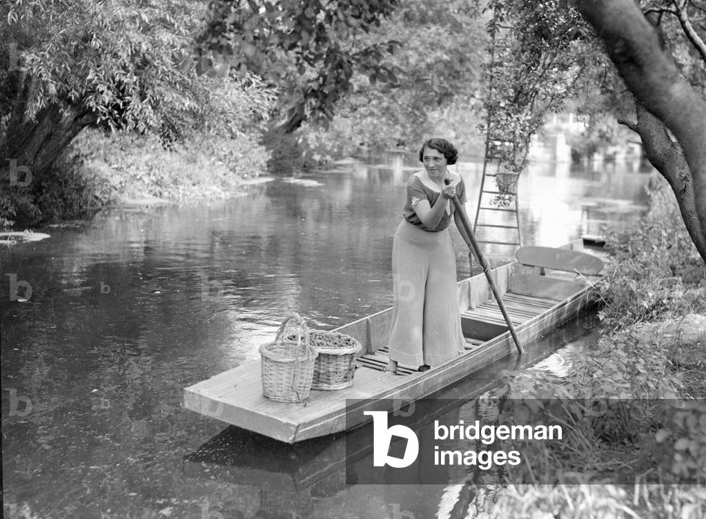 Mrs Page Smith and companions seen here at Island House, Longford, Middlesex, fruit picking from the river. September 1933