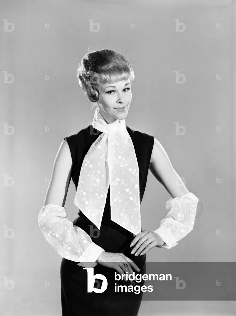 Clothing: Fashion: Woman wearing cravat and sleeves. Model: Jo Warring, March 1963 (b/w photo)