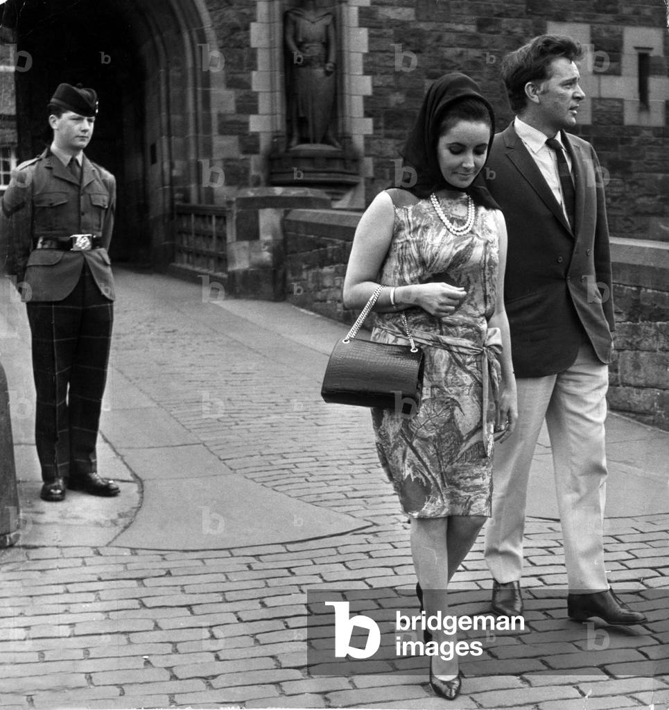 Actress Elizabeth Taylor with her husband Richard Burton walk away disappointed after not being allowed to enter Edinburgh Castle, 22nd July 1963 (b/w photo)