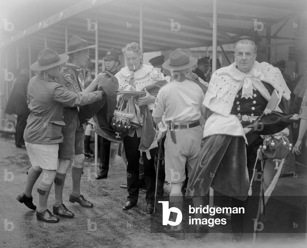 The Coronation of Queen Elizabeth II. Peers outside Westminster Abbey, assisted by boy scouts. 2nd June 1953 (b/w photo)