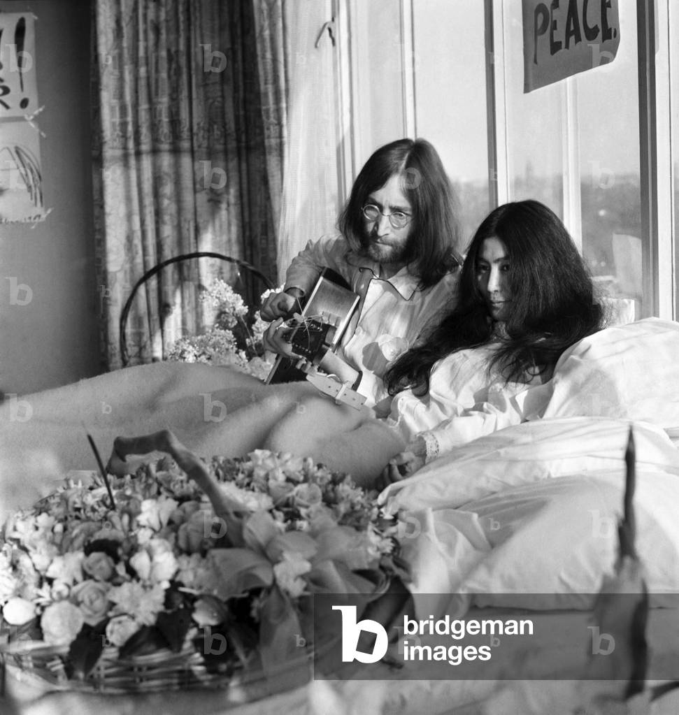 John Lennon and his wife Yoko Ono are having a weeks love-in their room at the Hilton Hotel, Amsterdam. They will stay in bed for seven days - with fruit, flowers and peace signs, March 1969