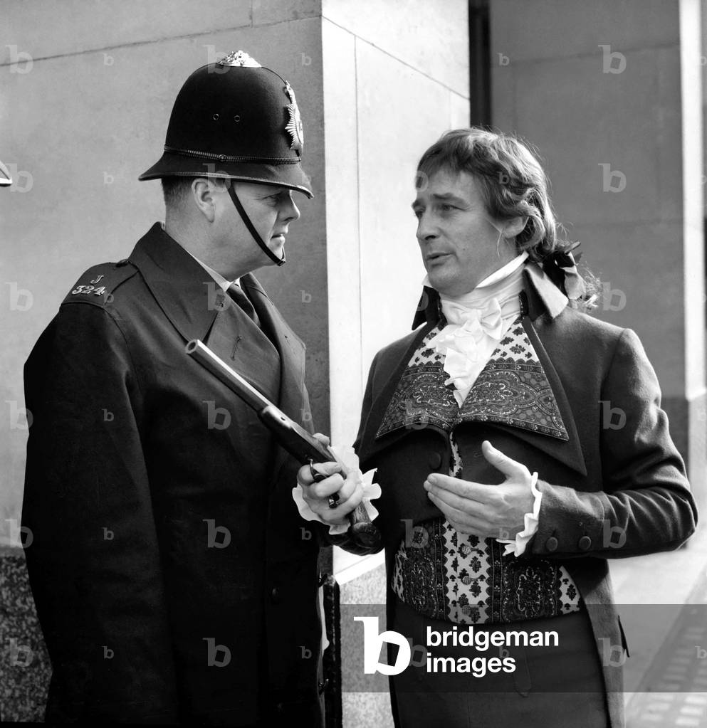 Edward Woodward actor who will be playing the part of Sydney Carton in Two Cities (opens 27th Feb. 1969) at the London Palace Theatre, pictured dressed in character & speaking with two police officers January 1969 (b/w photo)