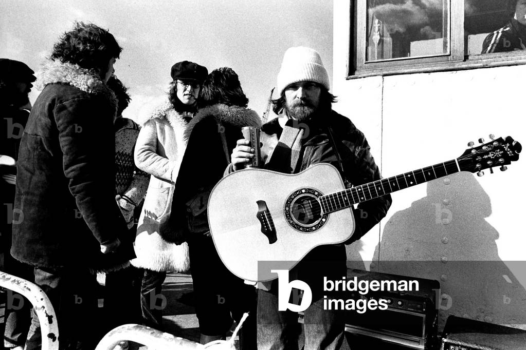 Lindisfarne sailed down the Tyne on a musical journey. The group were filming on board a Tyne ferry for a half-hour television show called 'All Right Now'. Ray Laidler and Si Cowe. 4th March, 1979 (b/w photo)