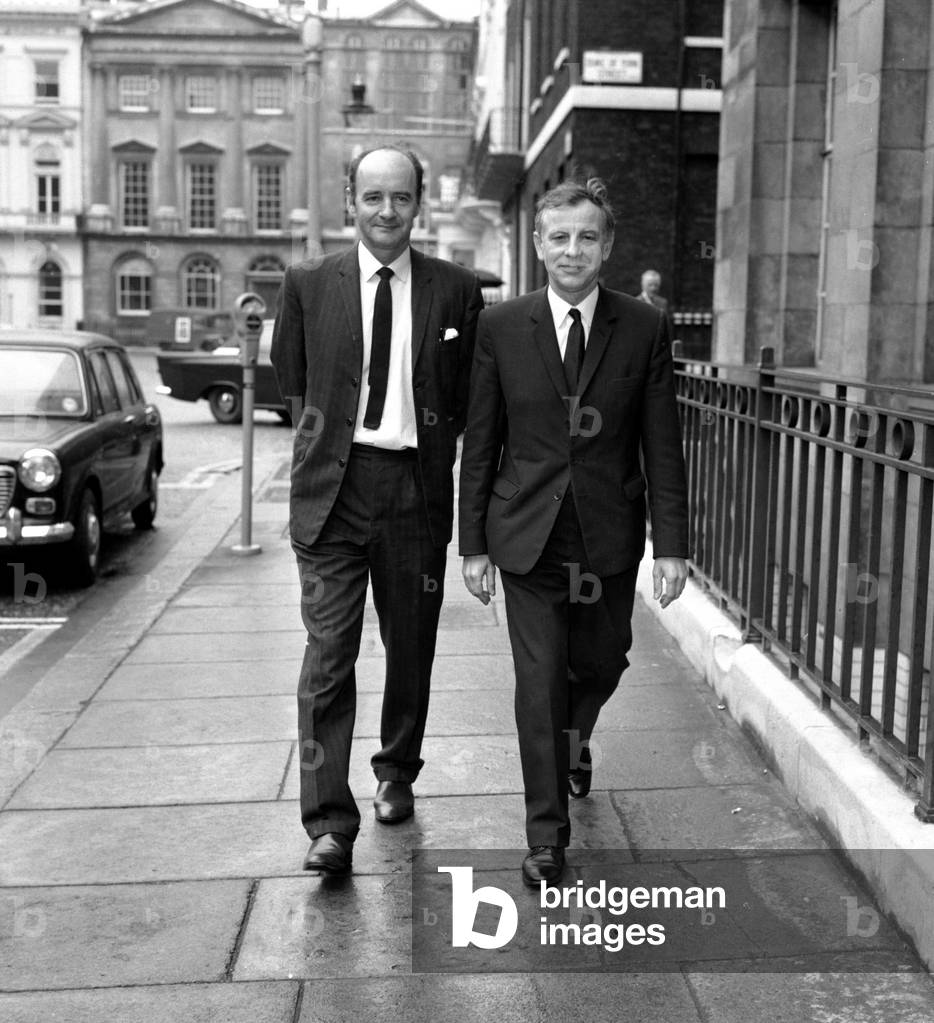 Women sewing machinists at the Ford Motor Company plant in Dagenham took strike action on 7 June, 1968 in support of a claim for regrading, parity with their male colleagues in the C pay grade and recognition of their skills. After 3 weeks on strike they settled for 92% of the C grade rate. Although not an equal pay strike, the strike was given a high profile when the whole plant was closed and Barbara Castle, the Employment Minister, was brought in to help negotiate a settlement. Picture shows AEF members Jock Macrea and Reg Birch arrive at the Ministry Building for the meeting between Barbara Castle and Ford Union representatives June 1968 (b/w photo)