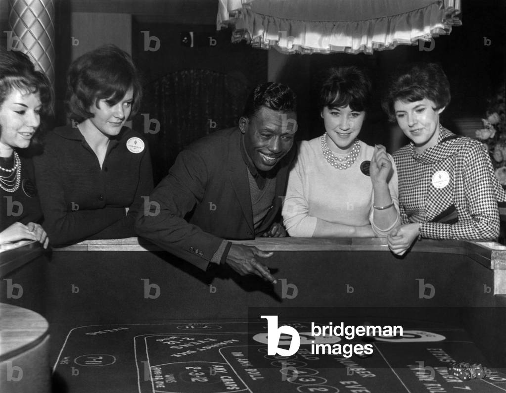 Boxer Joe (Old Bones) Brown in Manchester. Joe Brown throws the 'Bones' and gets a double six. February 1963