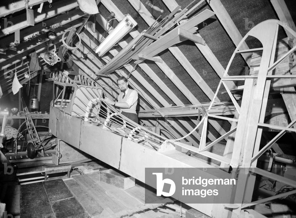 It started with small Airfix kits now this man's obsession with model aircraft has compelled him to build a full size light aircraft in his attic. c. 1960 (b/w photo)