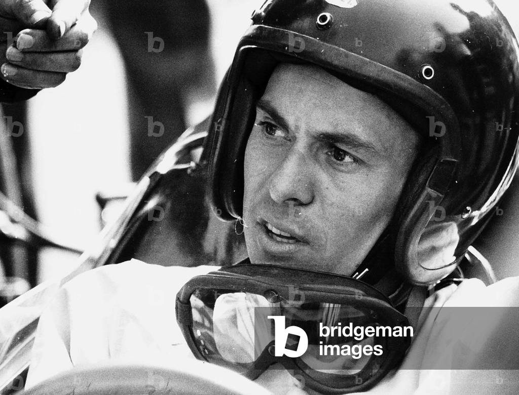 World champion racing driver Jim Clark wearing his helmet and goggles round his neck
April 1964