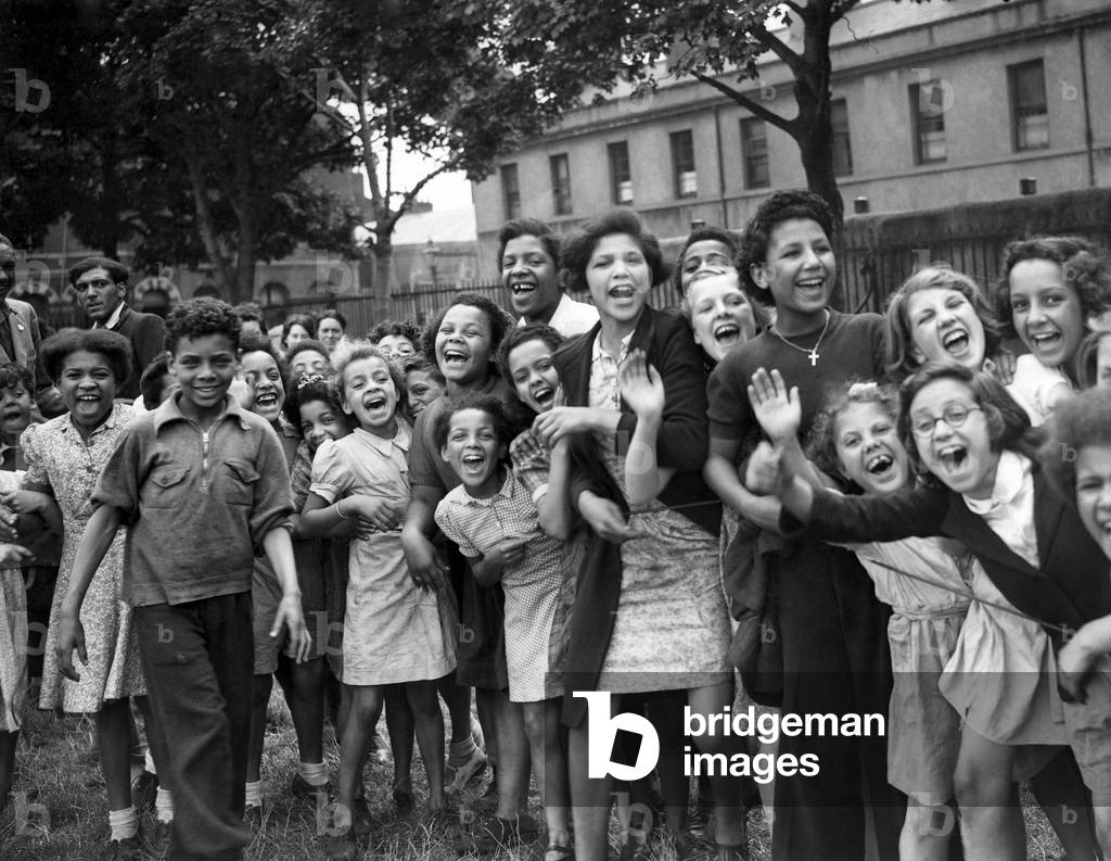 War Sport. Children of Cardiff's dockland held a sports meeting in connection with a holidays at home movement. Children seen here giving the competitors a 