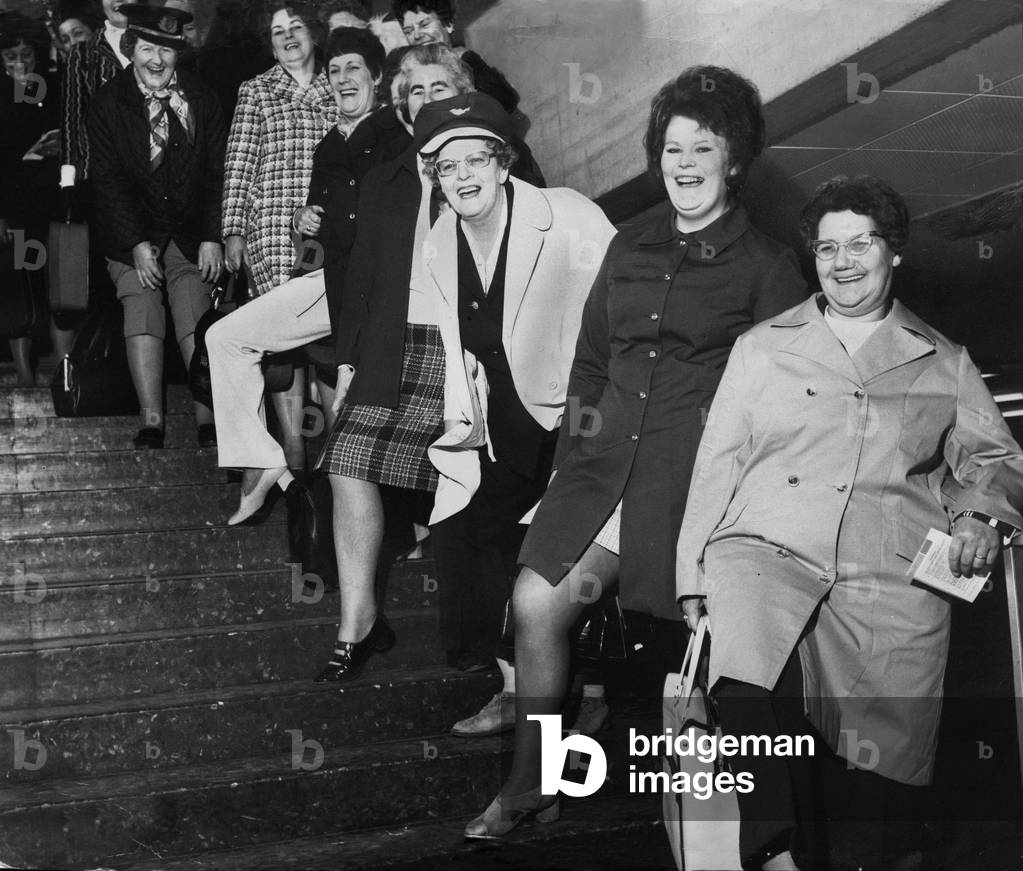 A group of Housewives pose for a picture before leaving Britain for a holiday in the Spanish resort of Benidorm, March 1973 (b/w photo)