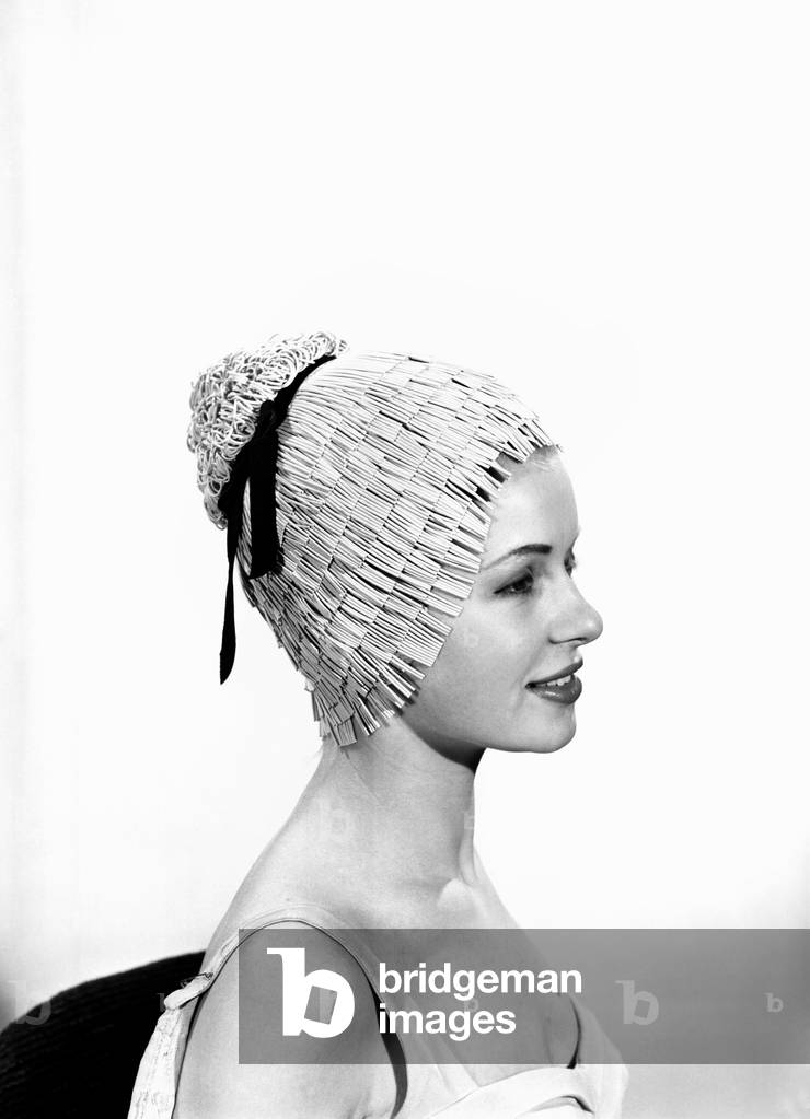 Model Vyvyan Dunbar wearing bathing hats, c. 1963 (b/w photo)