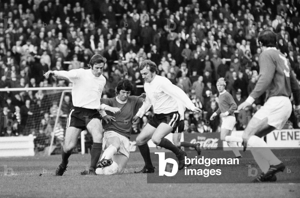 FA Cup First Round match at Craven Cottage. Fulham 1 v Bristol Rovers 2. Bristol's Brynley Jones takes the ball between Fulham pair Callaghan and Johnston, 21st November 1970 (b/w photo)