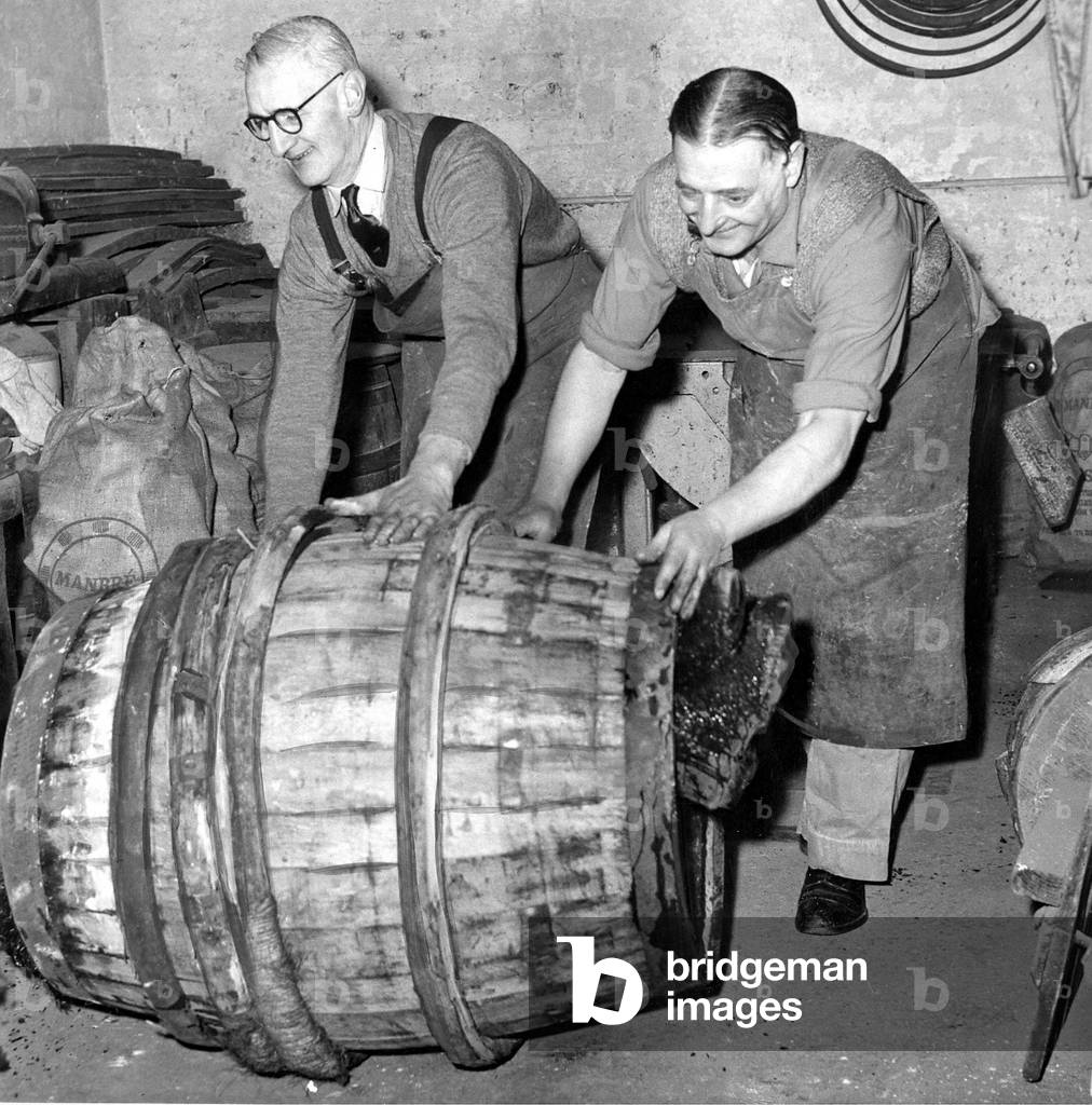 Coppers pushing a finished barrel made by an apprentice to mark the end of his five year apprenticeship at the Lion Brewery at West Hartlepool c,.1960