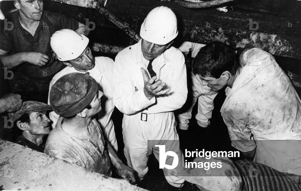 Prince Philip, Duke of Edinburgh, chats to a group of workers during his visit to the building of the new London Victoria underground, circa 01/06/1974