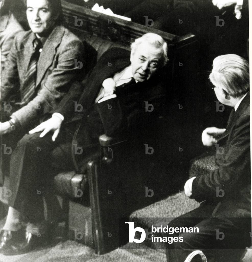 Prime Minister James Callaghan right and former Premier Sir Harold Wilson exchange words at the opening of the new session of Parliament while Dennis Skinner looks on, November 1976 (b/w photo)