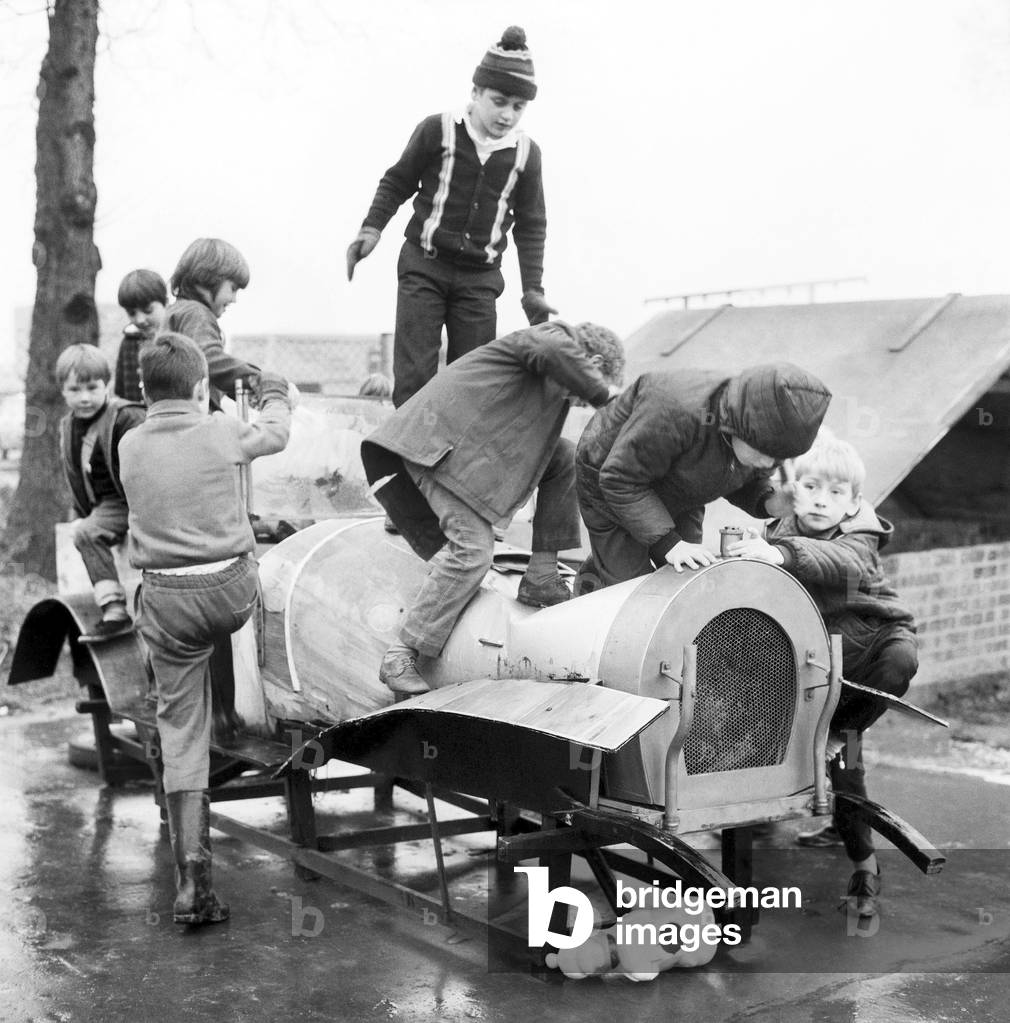 Children playing in the adventure playground at Basildon town centre, Essex. December 1969 (b/w photo)
