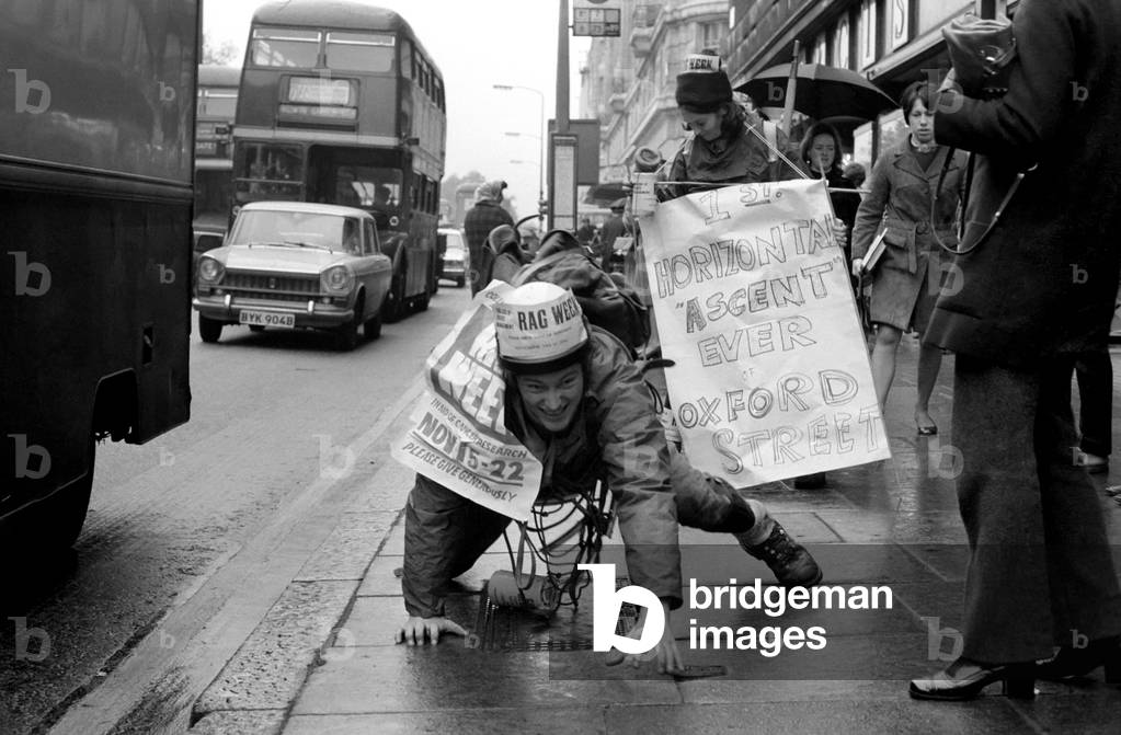 One of the six student mountaineers making a horizontal attempt on Oxford Street today, was John Phipps who comes from the College of Estate Management, Kensington. He inched his way from Marble Arch using cracks between paving stones to pull himself along - all in aid of the Cancer Research charity. John Phipps doing his climb up the Pavement November 1969